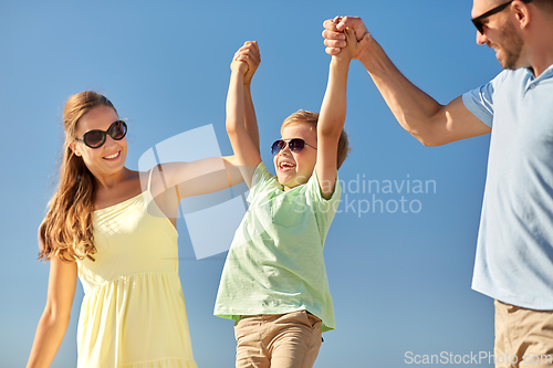 Image of happy family with child having fun in summer
