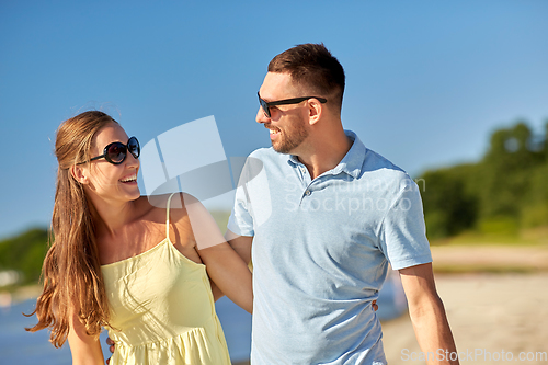 Image of happy couple hugging on summer beach