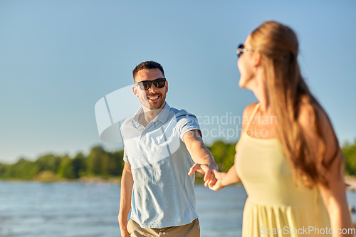 Image of happy couple hugging on summer beach