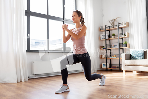 Image of young woman exercising at home