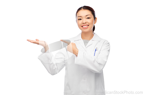 Image of asian female doctor holding something on hand