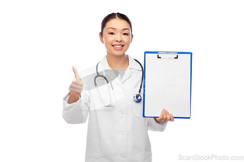 Image of asian female doctor with clipboard shows thumbs up