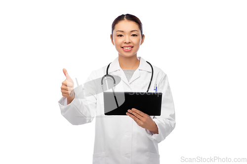 Image of asian female doctor with tablet pc shows thumbs up