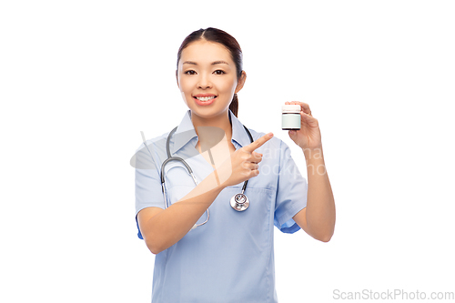 Image of smiling asian female doctor or nurse with medicine
