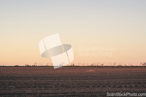 Image of Plowed field in the sunset at dawn