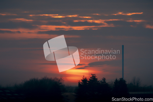 Image of Beautiful sunset over an industrial facility