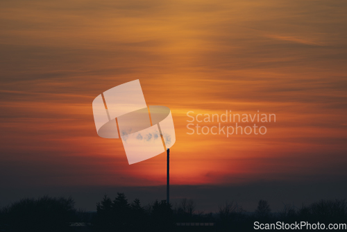 Image of Smoke from a chimey in a beautiful sunset