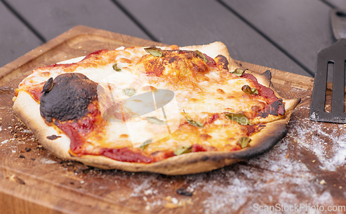 Image of Homemade pizza on a wooden board