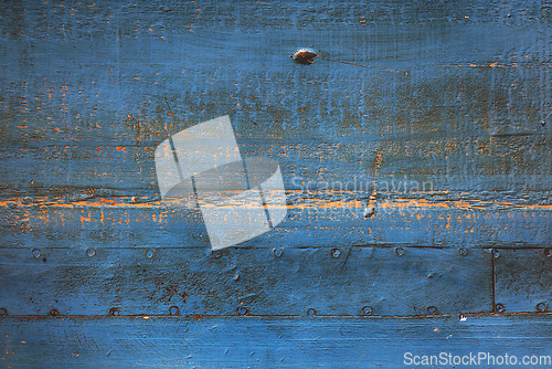 Image of Rusty blue metal surface with nails