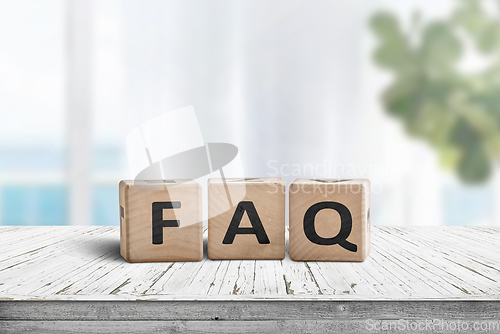 Image of FAQ answers and questions sign made of wooden blocks