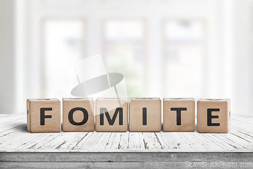 Image of Fomite sign made of blocks on a wooden table
