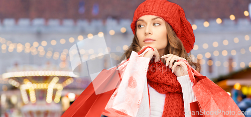 Image of woman with shopping bags over christmas market