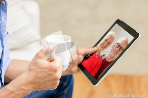 Image of close up of man having video call on tablet pc