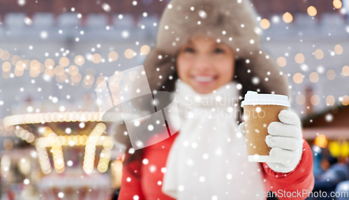 Image of happy woman drinking coffee at christmas market