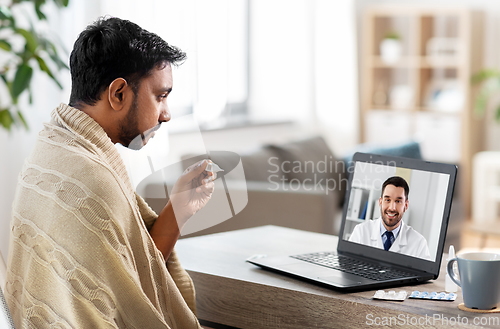 Image of sick man having video call with doctor on laptop