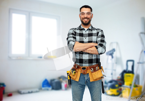 Image of happy male worker or builder with crossed arms