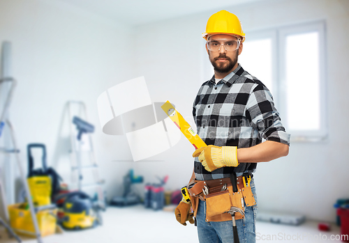 Image of male worker or builder in helmet with level