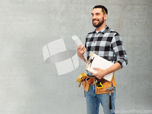 Image of male builder with clipboard and blueprint