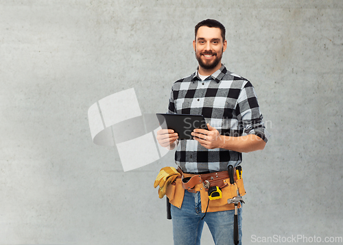 Image of happy builder with tablet computer and tools