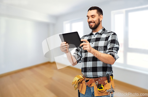 Image of happy builder with tablet computer and tools