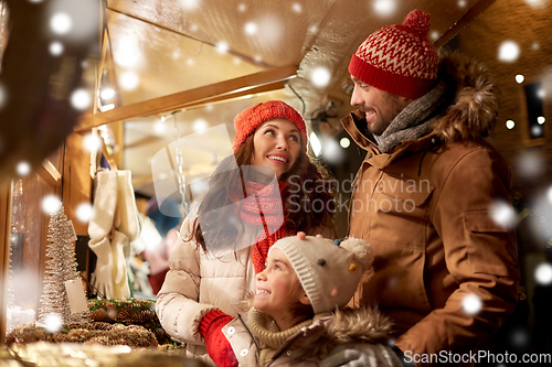 Image of happy family at christmas market in city