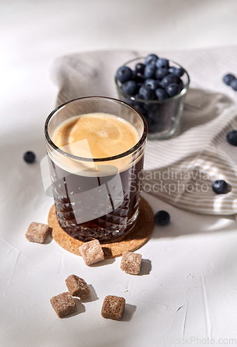 Image of glass of coffee, brown sugar and blueberries