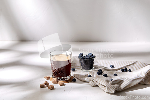 Image of glass of coffee, brown sugar and blueberries