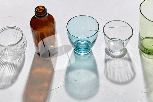 Image of glassware dropping shadows on white surface