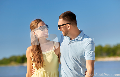 Image of happy couple hugging on summer beach