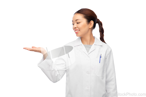 Image of asian female doctor holding something on hand