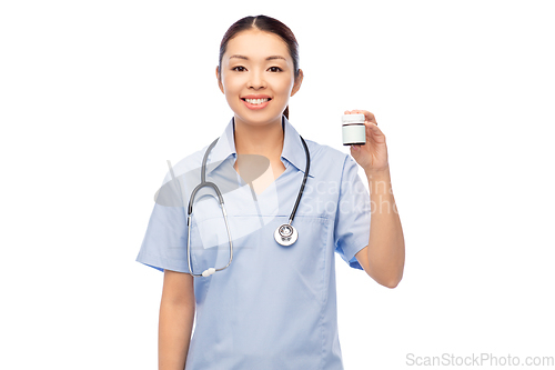 Image of smiling asian female doctor or nurse with medicine