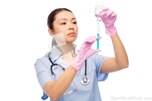 Image of asian female nurse with medicine and syringe