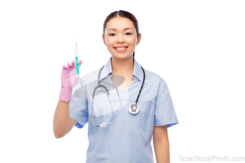 Image of happy asian female nurse with medicine and syringe