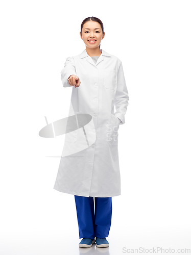 Image of happy asian female doctor pointing to camera