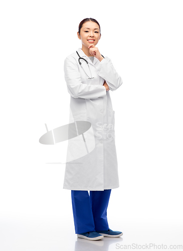 Image of thinking asian female doctor in white coat