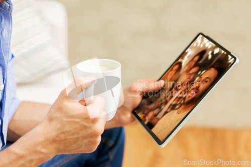 Image of man with tablet pc having video call with friends