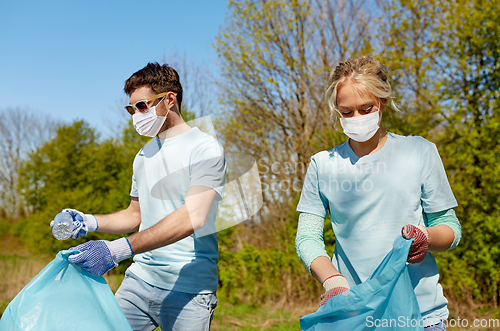 Image of volunteers with garbage bags cleaning park area