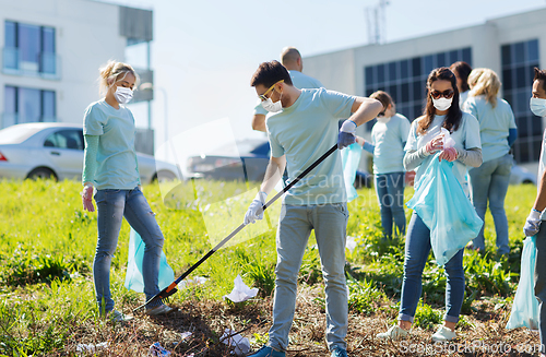 Image of volunteers with garbage bags cleaning park area