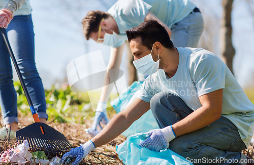 Image of volunteers with garbage bags cleaning park area