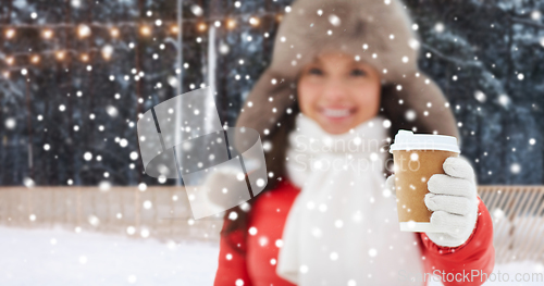 Image of happy woman with coffee cup over winter ice rink