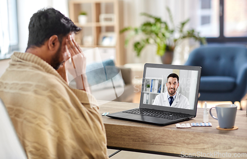 Image of sick man having video call with doctor at home