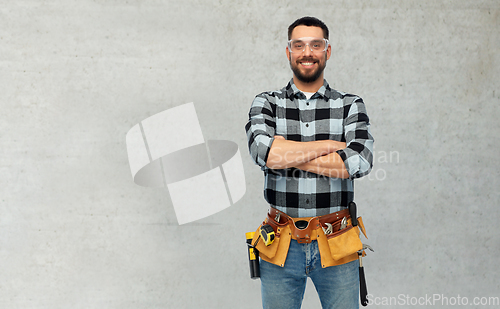 Image of happy male worker or builder with crossed arms