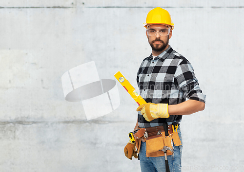 Image of male worker or builder in helmet with level