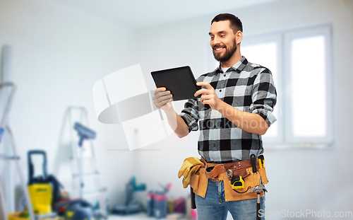 Image of happy builder with tablet computer and tools