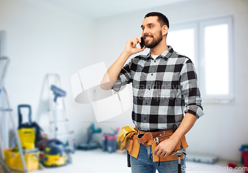 Image of builder in helmet calling on smartphone