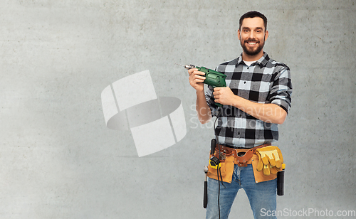 Image of happy male worker or builder with drill and tools