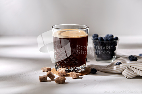 Image of glass of coffee, brown sugar and blueberries