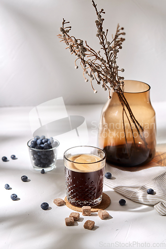 Image of glass of coffee, brown sugar and blueberries