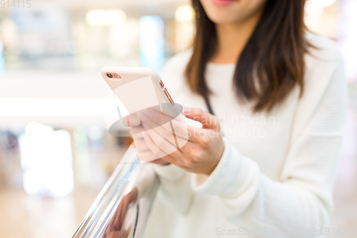 Image of Woman sending sms on cellphone