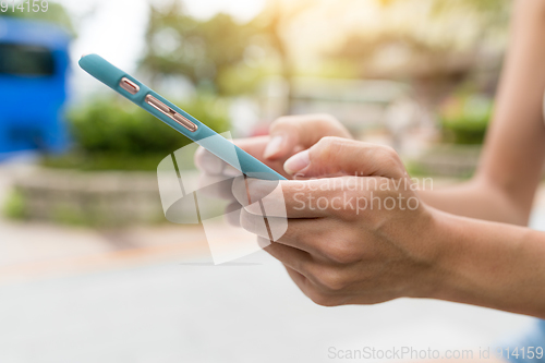 Image of Using mobile phone in the street